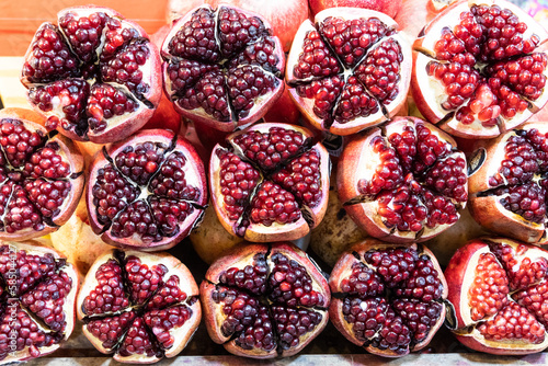 Closeup of Pomegranate fruit halved revealing its arils or seeds is on of the popular super food. photo