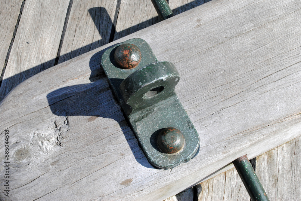 Close Up of Metal Bracket on Teak Deck of Old Sailing Ship 