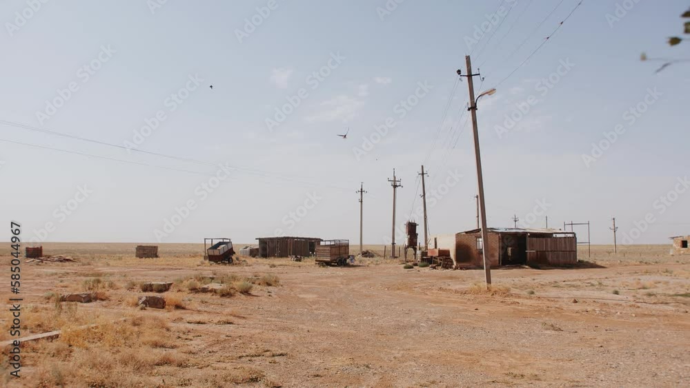 Operating and abandoned buildings next to electrical panels and semi-trailers in the steppe. abandoned area Operating and abandoned buildings next to electrical panels and semi-trailers in the steppe. abandoned area