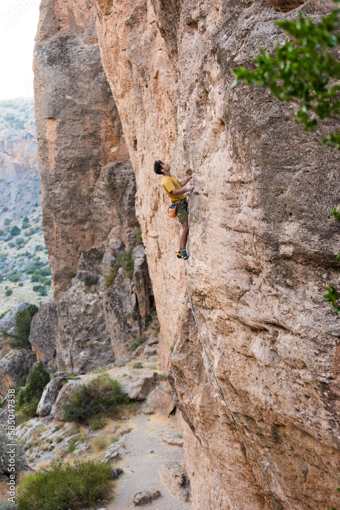 climber climbs the wall. a man is engaged in sport climbing. climber climbs the wall. a man is engaged in sport climbing.