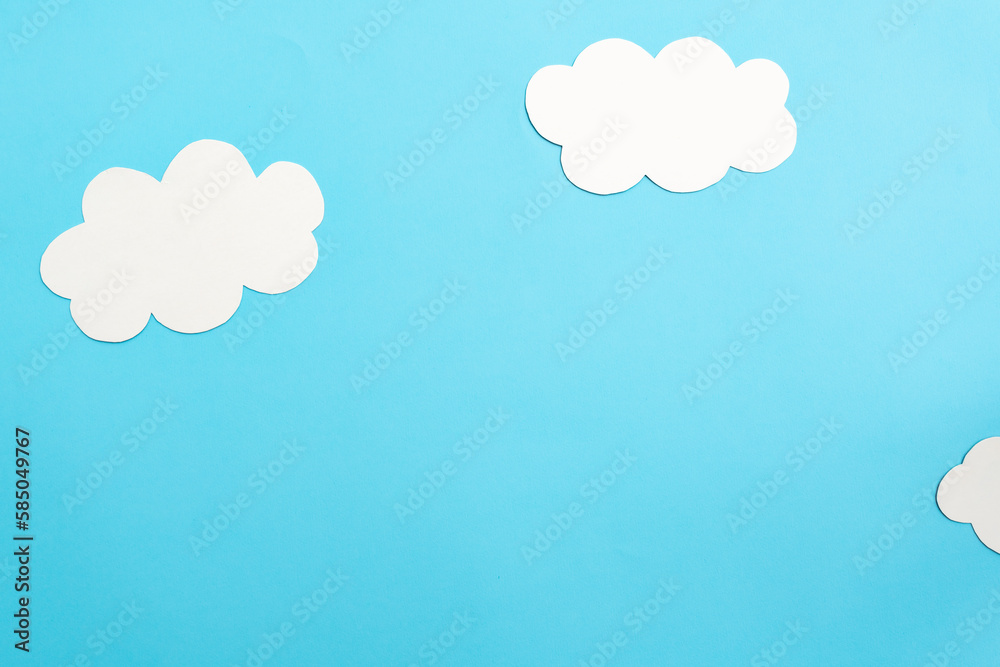 Paper clouds on blue background, flat lay, top view