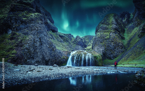 Icelandic Landscape. Scenic image of fairy-tale Stjornarfoss waterfall with Green northern lights. Iconic location for landscape photographers. Iceland, Europe. Incredible vivid landscape of Iceland. photo