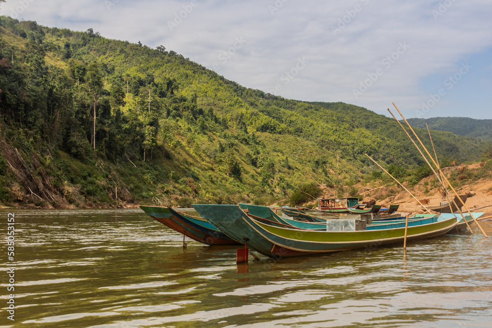 Boats at Nam Ou river in Phongsali province, Laos Boats at Nam Ou river in Phongsali province, Laos