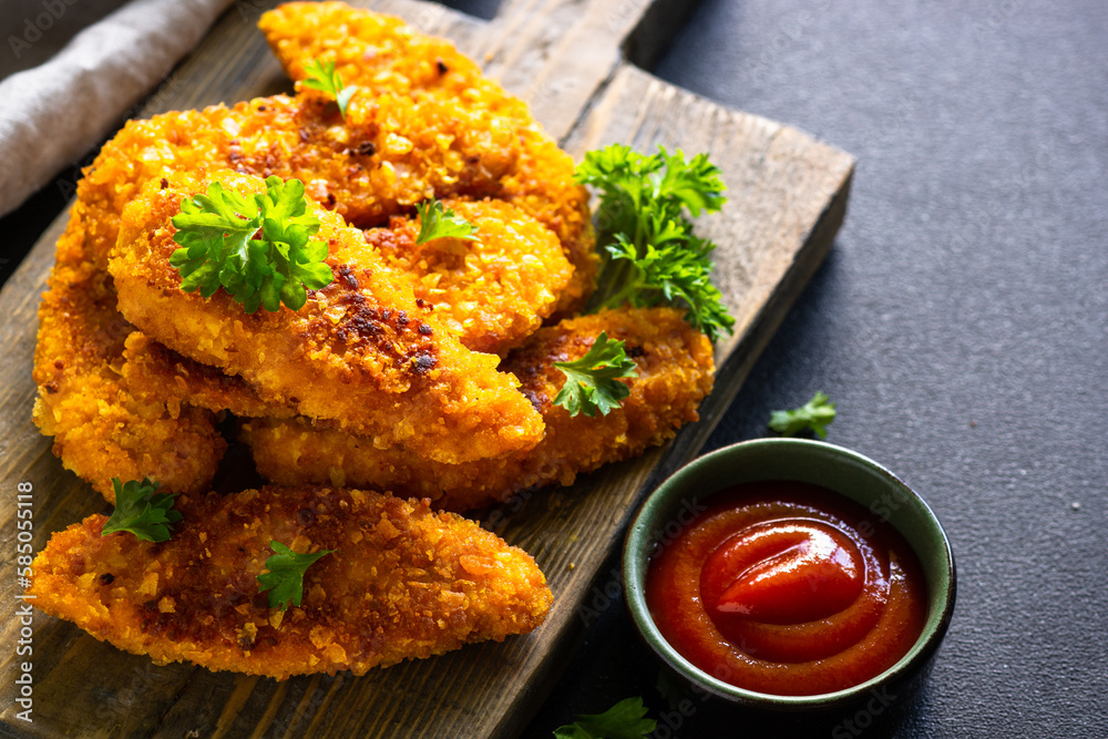 Chicken nuggets with ketchup sauce on wooden serving board. Chicken nuggets with ketchup sauce on wooden serving board.