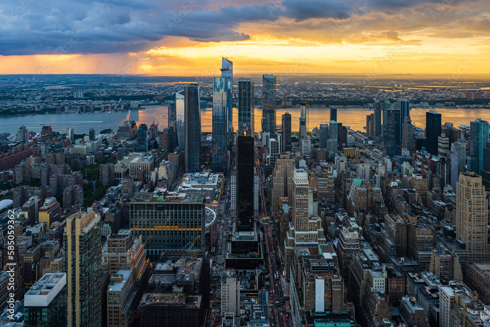 A rain storm over the Hudson Yards in New York City during beautiful sunset.