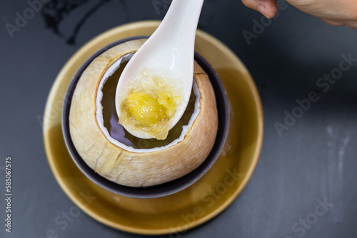 Bird's nest with gingko, double boiled in coconut in Bangkok street stall. Delicacy among the Chinese believed to have anti-agening propeties. photo