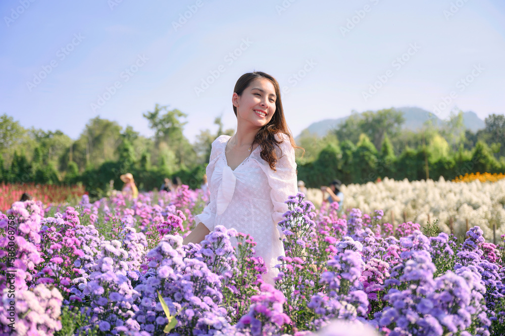 Young asian woman wear white dress enjoying and smiling on lavender blooming field Young asian woman wear white dress enjoying and smiling on lavender blooming field
