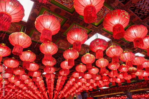 Red chinese lantern glowing ornamental hanging on ceiling of chinese temple