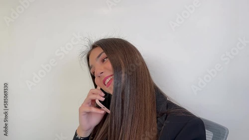Happy young woman talking on the phone