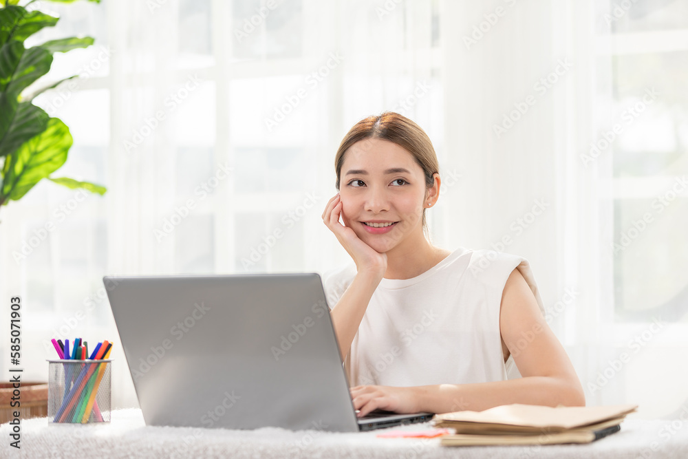 Modern and successful Asian woman working on her laptop with a bright smile. Embodies productivity, efficiency, Balance between work and happiness. For promoting career advancement and technology Modern and successful Asian woman working on her laptop with a bright smile. Embodies productivity, efficiency, Balance between work and happiness. For promoting career advancement and technology