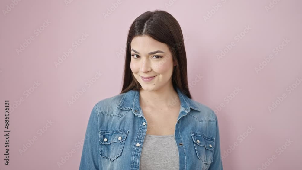 Young beautiful hispanic woman smiling confident saying yes with head over isolated pink background Young beautiful hispanic woman smiling confident saying yes with head over isolated pink background