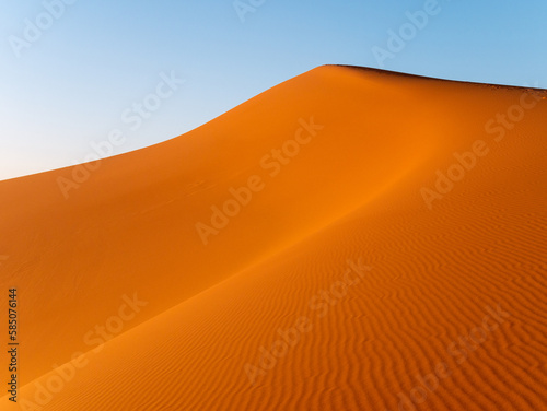 Intricate wavy patterns seen on dunes near Merzouga, Morocco during sunset - Landscape shot