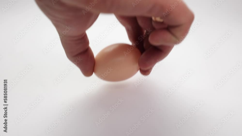 Broken egg on a white background. Homemade egg, white and yolk. Preparing breakfast. Chicken egg is brown, raw. Cracked shell, from a fall Broken egg on a white background. Homemade egg, white and yolk. Preparing breakfast. Chicken egg is brown, raw. Cracked shell, from a fall