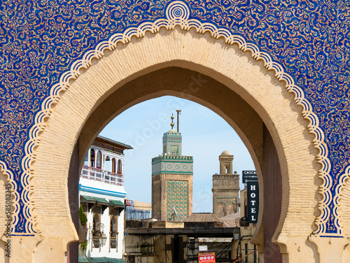 Minaret of the Bou Inania Madrasa seen through the iconic Bab Bou Jeloud in Fez, Morocco on a sunny afternoon photo