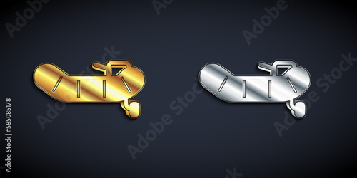 Gold and silver Inflatable boat with outboard motor icon isolated on black background. Long shadow style. Vector
