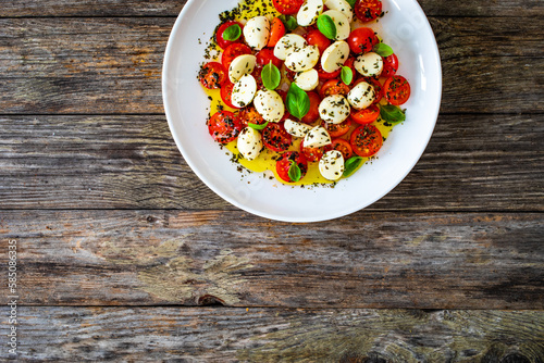 Caprese salad on wooden board 