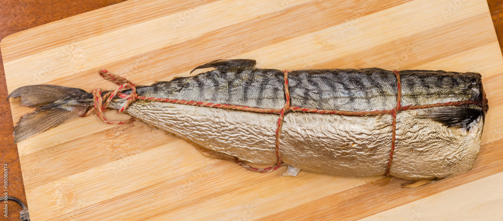 Hot-moked Atlantic mackerel on cutting board, top view closeup Hot-moked Atlantic mackerel on cutting board, top view closeup