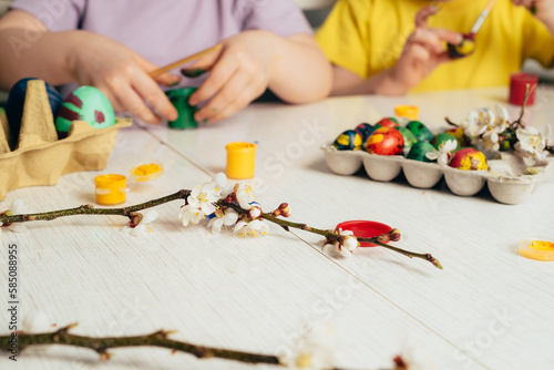 Children's hands that close the can of paint. Preparing for a happy easter holiday