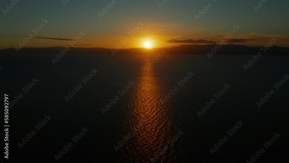 Sunset above the sea surface with waves, top view. Reflected sun on a water surface. Sunset over ocean. Seascape, Summer and travel vacation concept Sunset above the sea surface with waves, top view. Reflected sun on a water surface. Sunset over ocean. Seascape, Summer and travel vacation concept