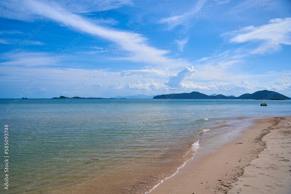 View from the sandy beach to the silhouettes of islands in the sea. Beautiful beach of Thailand