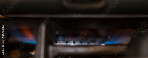 Detailed vieuw of gas burning with blue flame on a cooking stove. Energy. Expensive. sustainability. photo