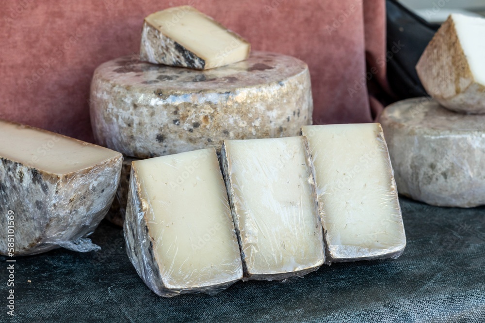 Cheese made with organic milk with aromatic herbs. Stall in a market of organic products