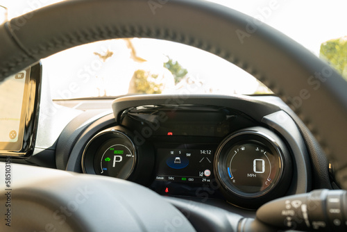 Cockpit view of a new, Japanese hybrid hatchback car. Showing the dual LCD dashboard and part of the large LCD navigation display on the left. © Nick Beer