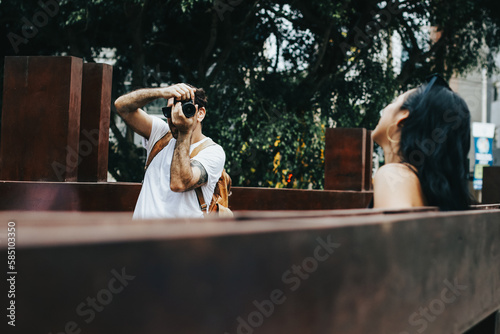 Photograph of man taking pictures with a camera of a girl. Concept of vacation, tourism, and lifestyle.