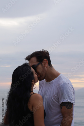 photo of couple kissing in summer. Concept of couples.