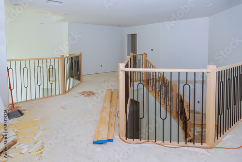 As part of construction process new residence wooden railing is being assembled and installed photo