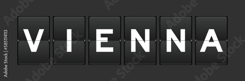 Black color analog flip board with word vienna on gray background