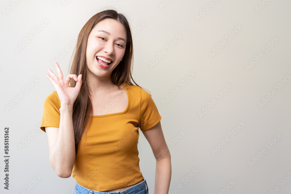 Woman doing hand sign ok isolated on background.