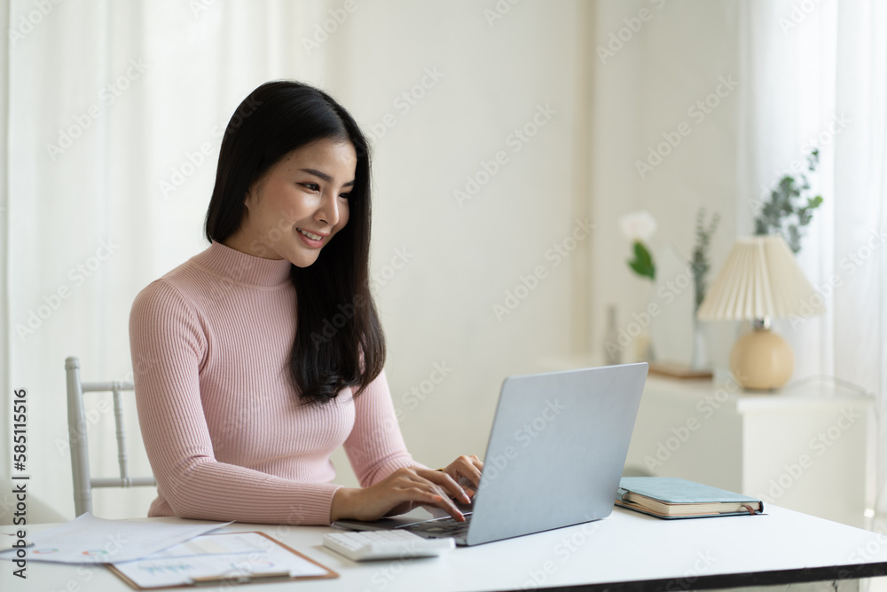 Portrait of beautiful Asian business woman working on her project while using laptop computer. Portrait of beautiful Asian business woman working on her project while using laptop computer.