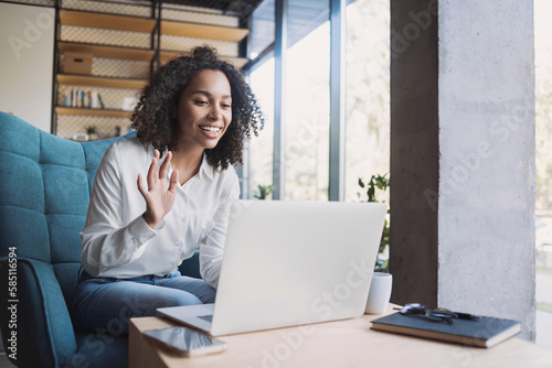 Online business meeting  Smiling african american woman speak on video call conference  Young businesswoman or freelancer working remotely on laptop computer