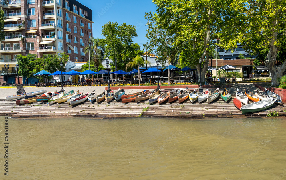 Row of canoes and kayaks for rent on the promenade of Tigre in Argentina on the Parana delta