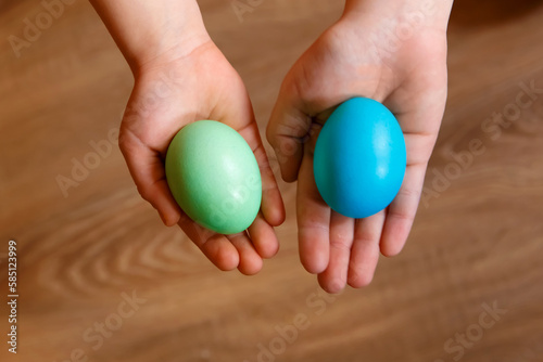 Paint eggs for Easter, bright Easter holiday, children paint eggs, colored eggs in a basket, colored eggs on a stand, Holiday background 