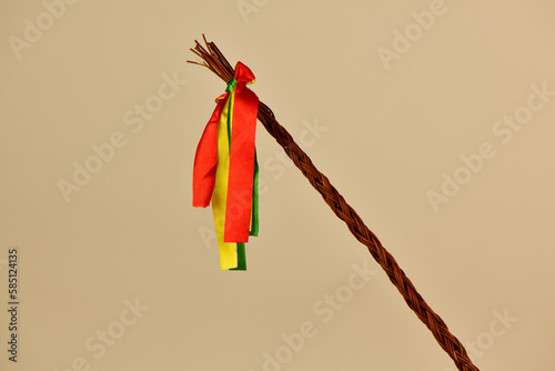 Traditional Czech Easter whip with colored ribbons 
from willow branches on the light background 