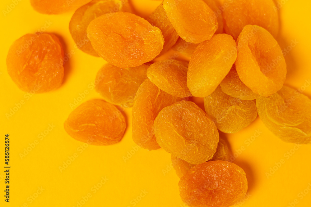 Dried apricots on a yellow background. Dried apricot.
Dried apricots on a yellow background. Dried apricot.