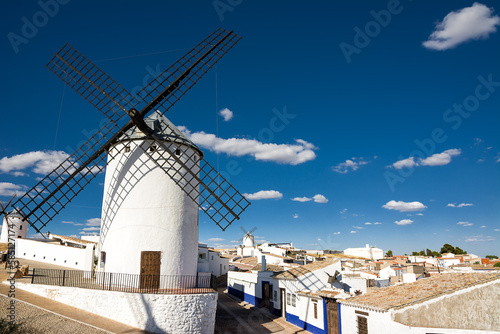Ancient windmills near houses in Campo de Criptana, Spain, defined in Cervantes' Don Quixote "The Giants"