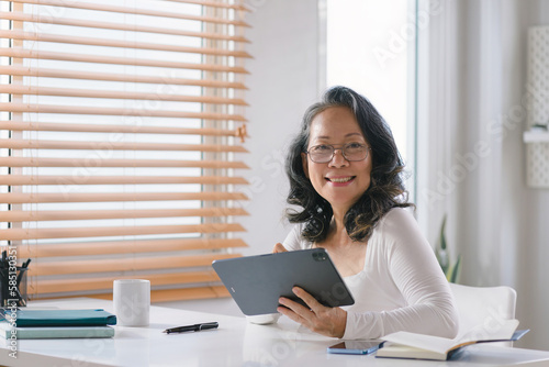 Portrait of a Senior businesswoman entrepreneur working remotely from her home office. © kenchiro168