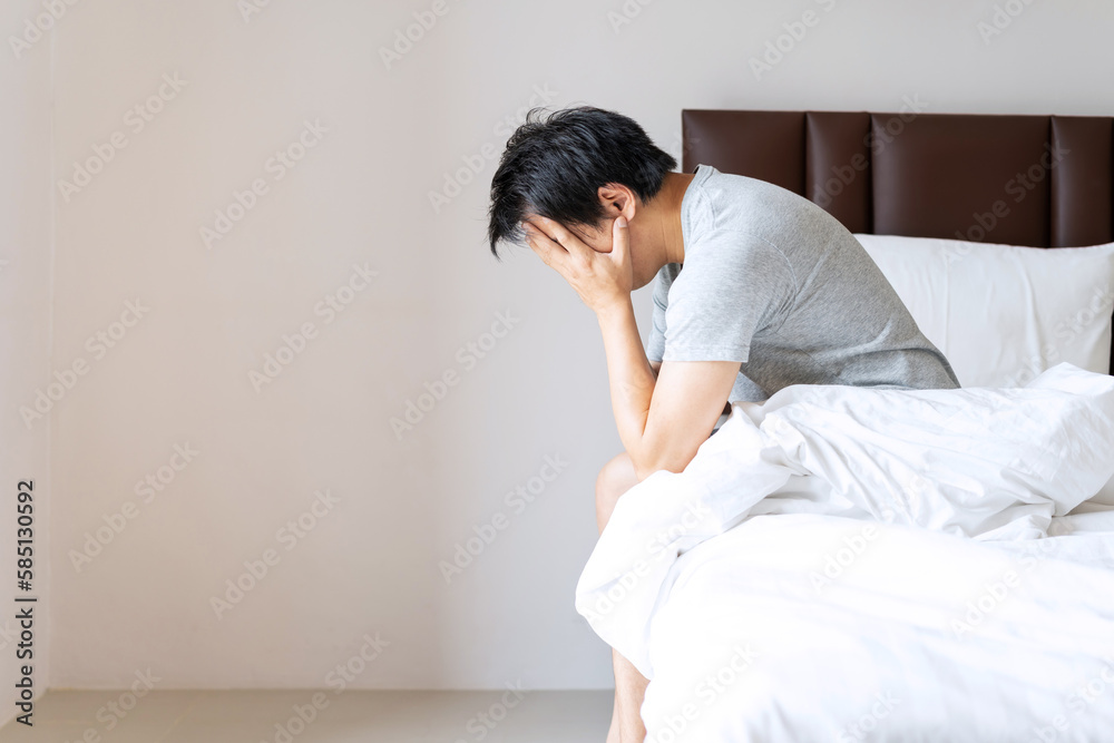 Lonely young man depressed and stressed sitting in the bedroom, Negative emotion and mental health concept - obrazy, fototapety, plakaty 