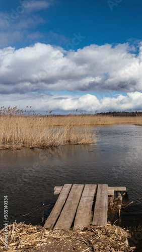 4k timelapse of Braslaw lake Dryaviaty in Belarus with pier and clouds. Vertical video photo