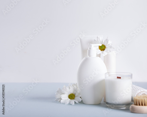 Blank mock up bottles beauty cosmetic skin care organic product for bathing routine with flowers chamomile. Place your design.