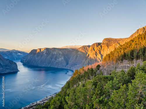 Aurlandsfjord and the mountain peaks lit up at sunset during autumn season in Vestland, Sogn, Norway