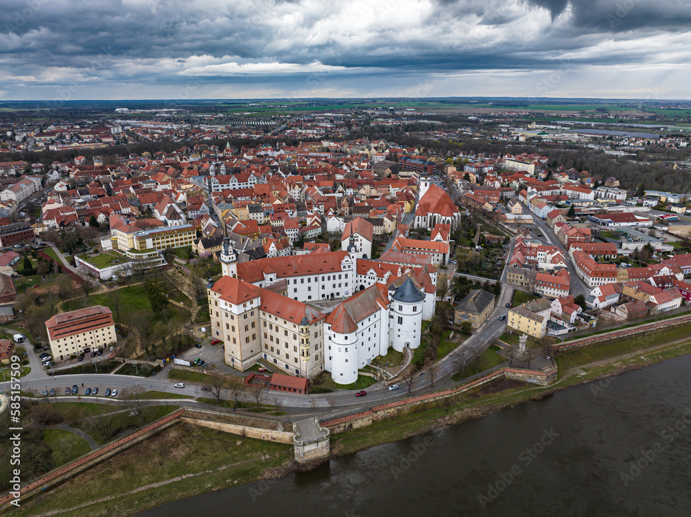 city view of torgau in rainy weather. Hartenfels Castle in the center. dark clouds frame the city center