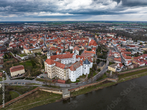city view of torgau in rainy weather. Hartenfels Castle in the center. dark clouds frame the city center