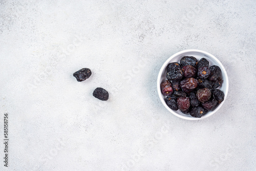 Raw Organic Arabic Dates, Ajwa Dates on light gray background. Ramadan Kareem. Top View.