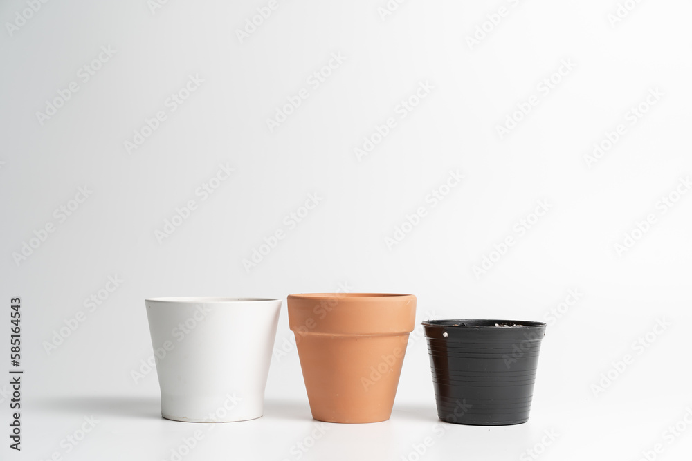 Various pot comparison in isolated white background. Ceramic, Terracotta and Plastic pots comparison Various pot comparison in isolated white background. Ceramic, Terracotta and Plastic pots comparison