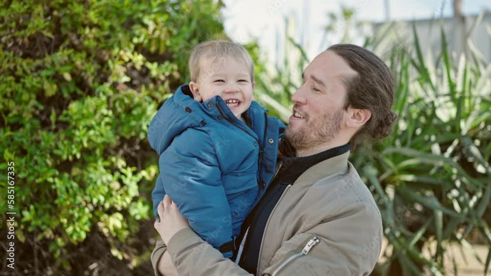 Father and son smiling confident hugging each other at park Father and son smiling confident hugging each other at park