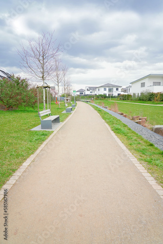 Wallpaper Mural Walkway with benches in nature, park green meadow grass between quiet settlement with family houses for walks Torontodigital.ca